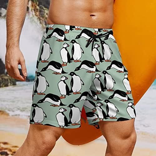 גזעי שחייה של פינגווין ופינגווין עם מכנסי מתיחה של דחיסה לספורט בגד ים בגלישה בחוף הים